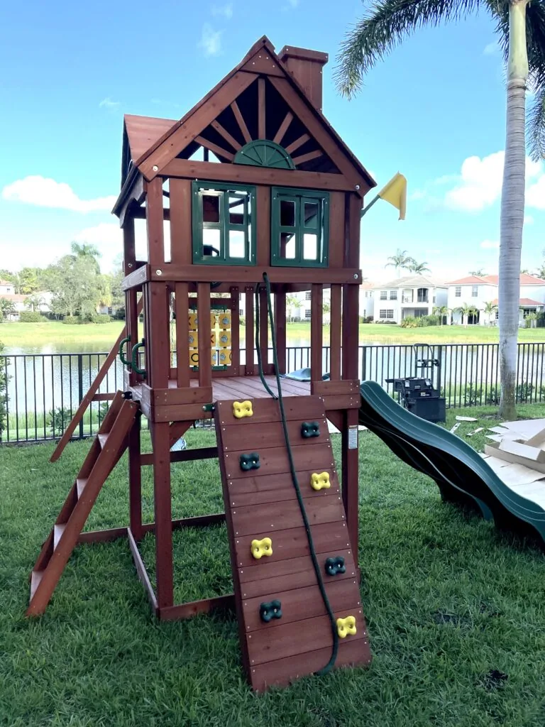 Backyard playset with climbing wall and swings