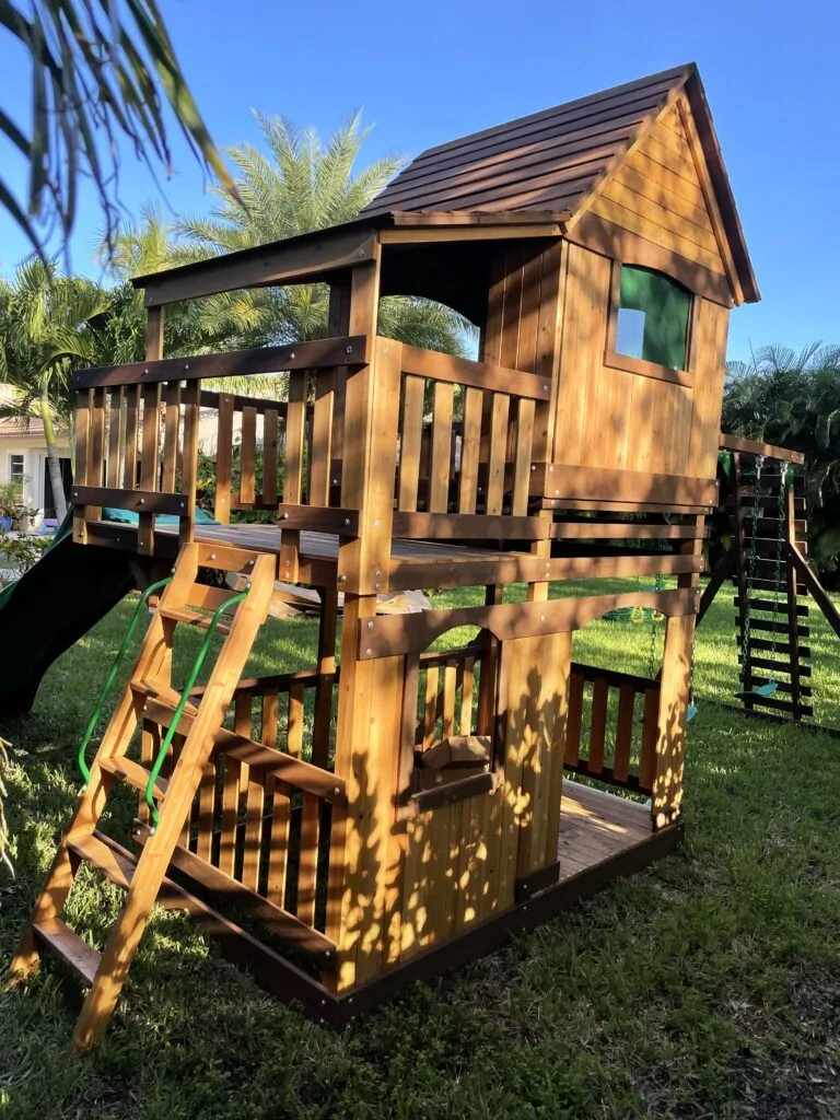 Two-story wooden backyard playhouse assembled by David